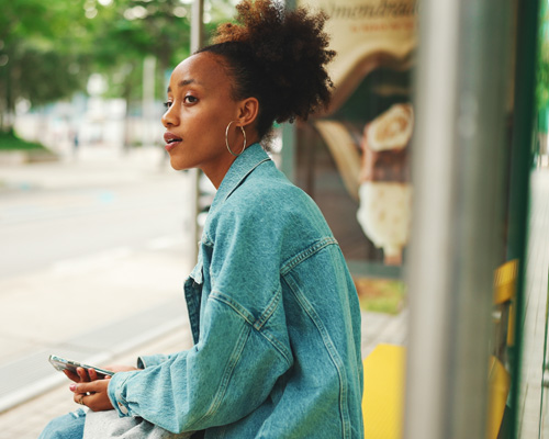 Image of woman at bus stop